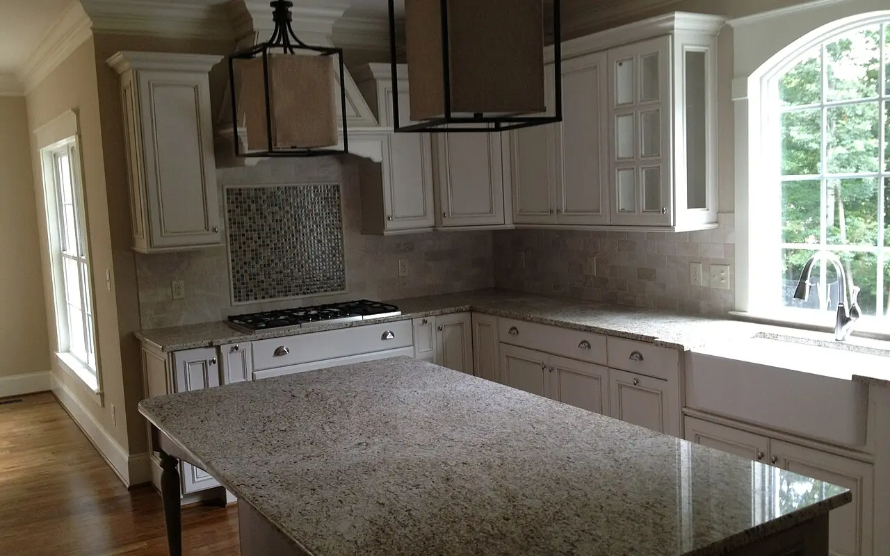 Kitchen with dark cabinets and marble countertops