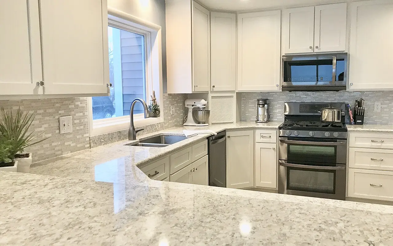 White kitchen cabinets with a central island
